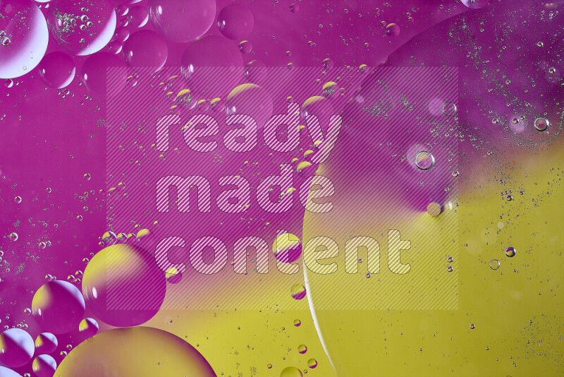 Close-ups of abstract oil bubbles on water surface in shades of yellow and pink