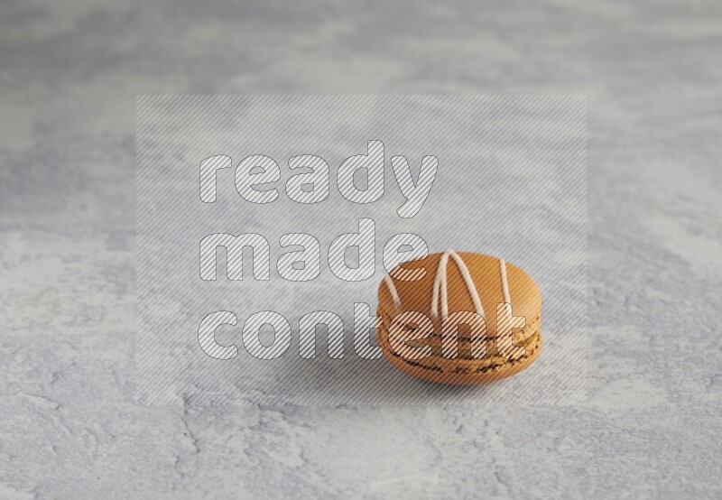 45º Shot of Brown Irish Cream macaron on white marble background