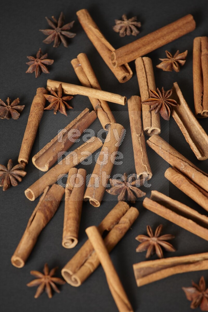 Cinnamon sticks and star anise on black background