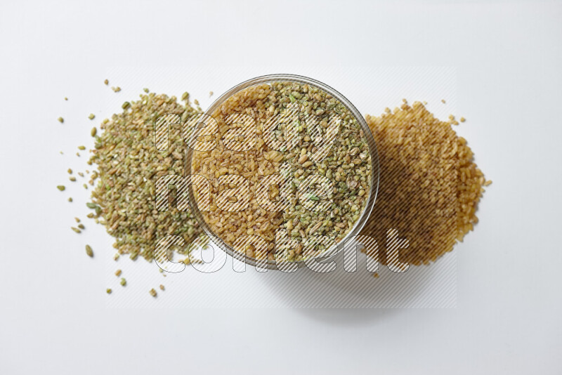 Coarse bulgur with freekeh on white background