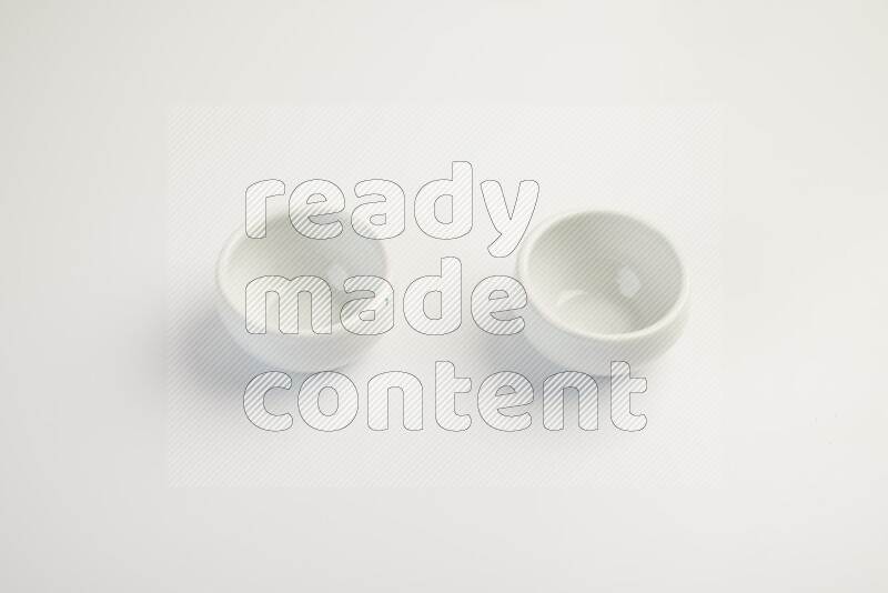 white ceramic round sauce dish on white countertop