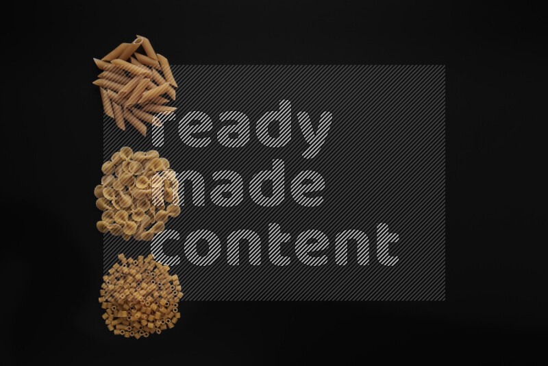 Different pasta types in 3 bunches on black background