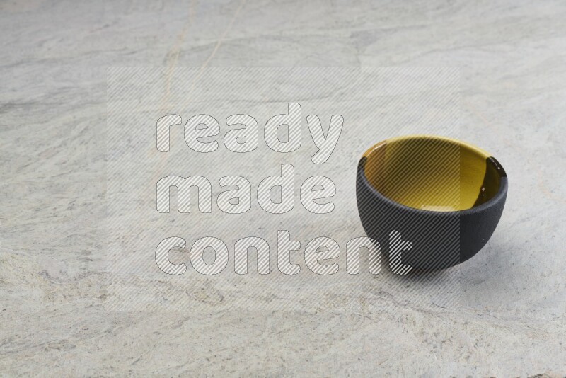 A multicolored pottery bowl on grey marble background