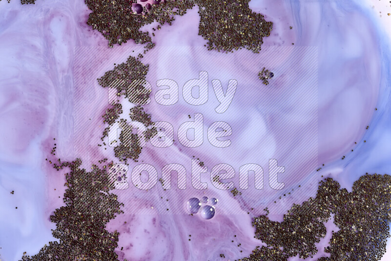 A close-up of sparkling gold glitter scattered on swirling blue and red background