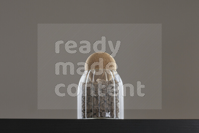 Buttons in a glass jar on black background